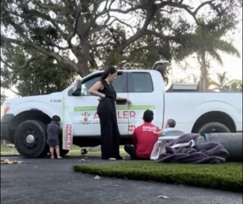 Andrea with her family beside the Angler landscaping truck